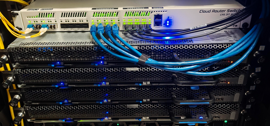 Four servers and a router racked.