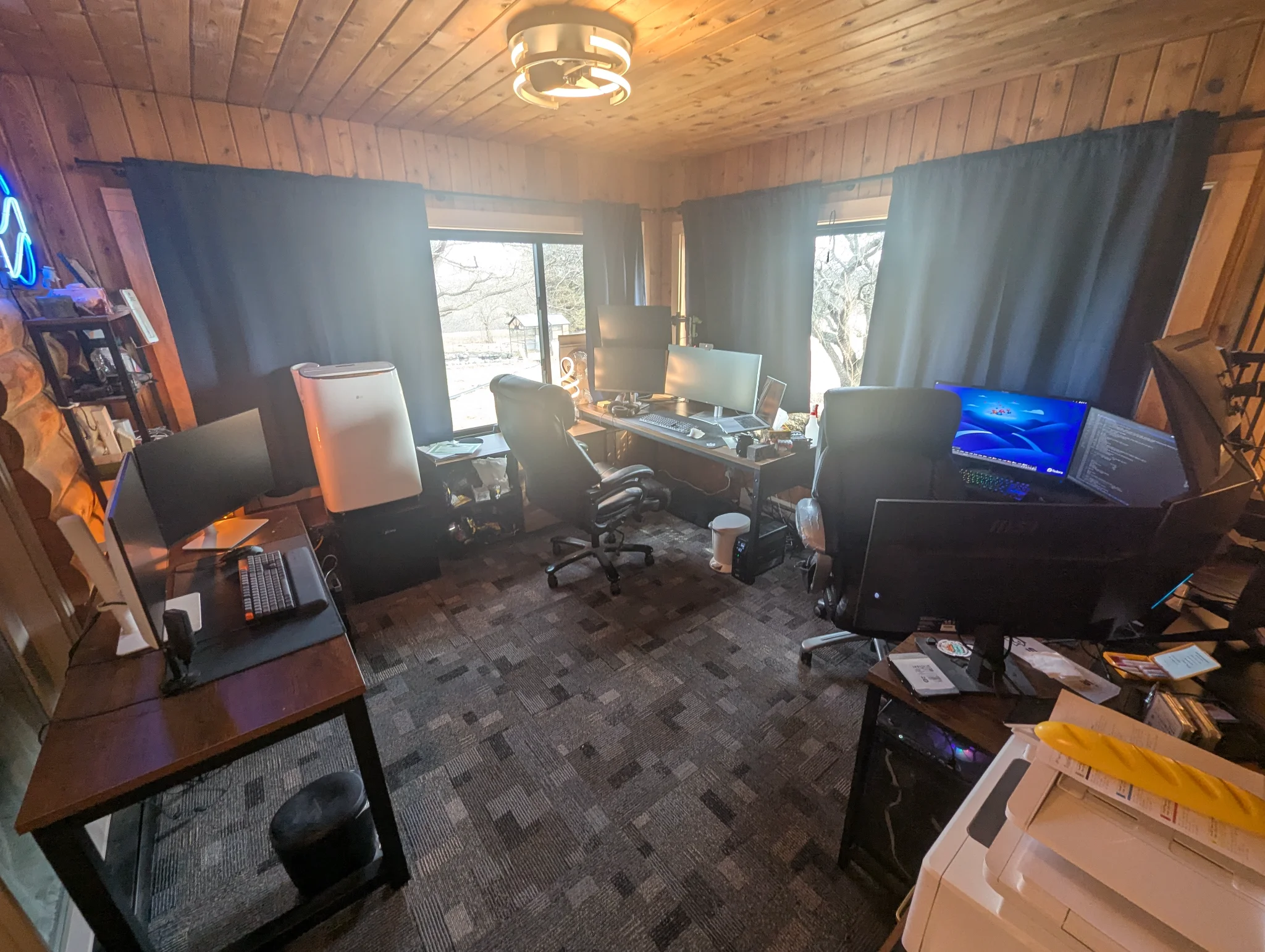 A picture of an office with way too many computers.